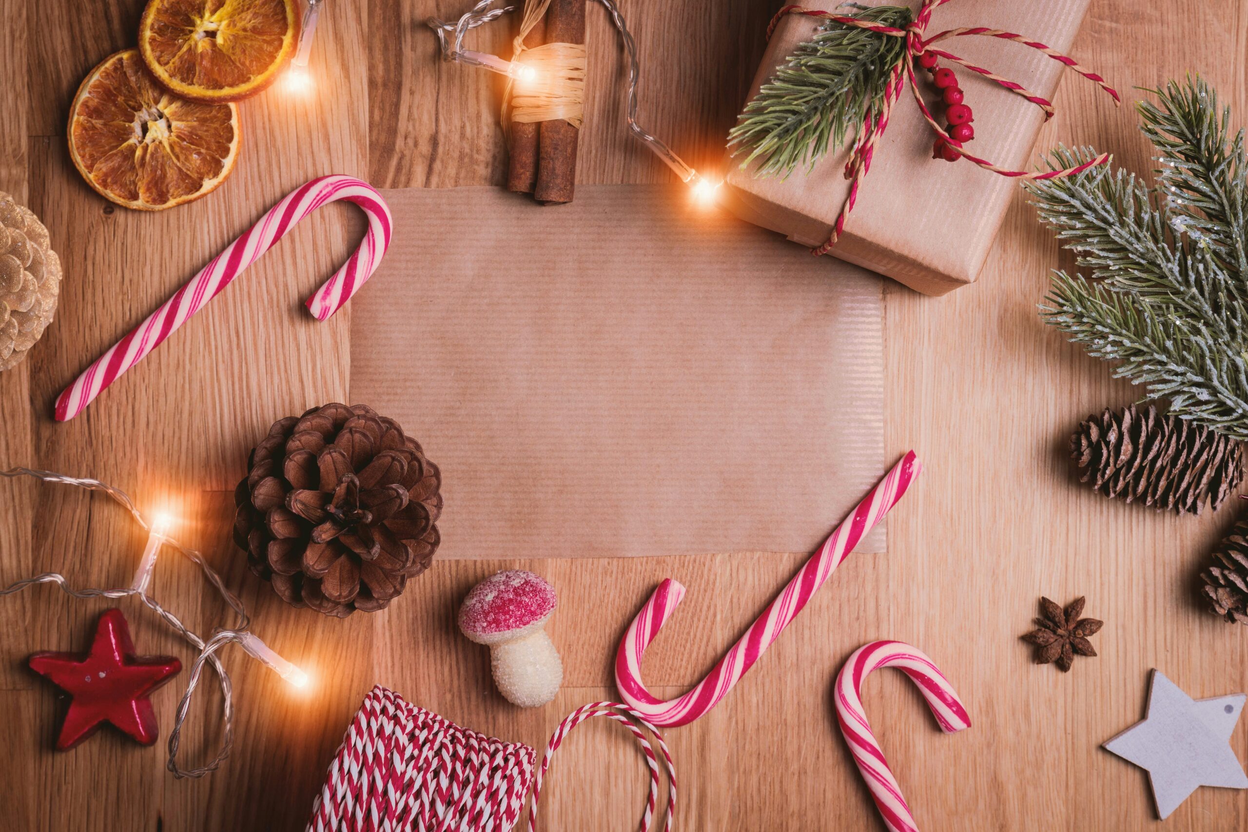 Holiday background with candy canes and pine cones